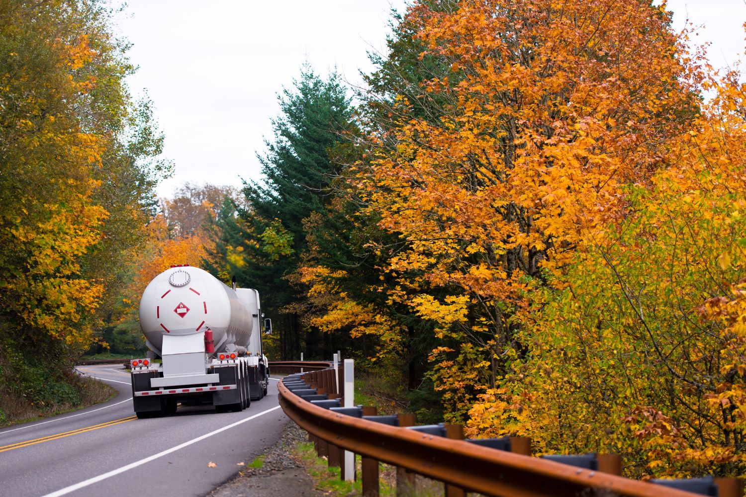 Image of a Tanker Truck Driving Down a Road during Autumn