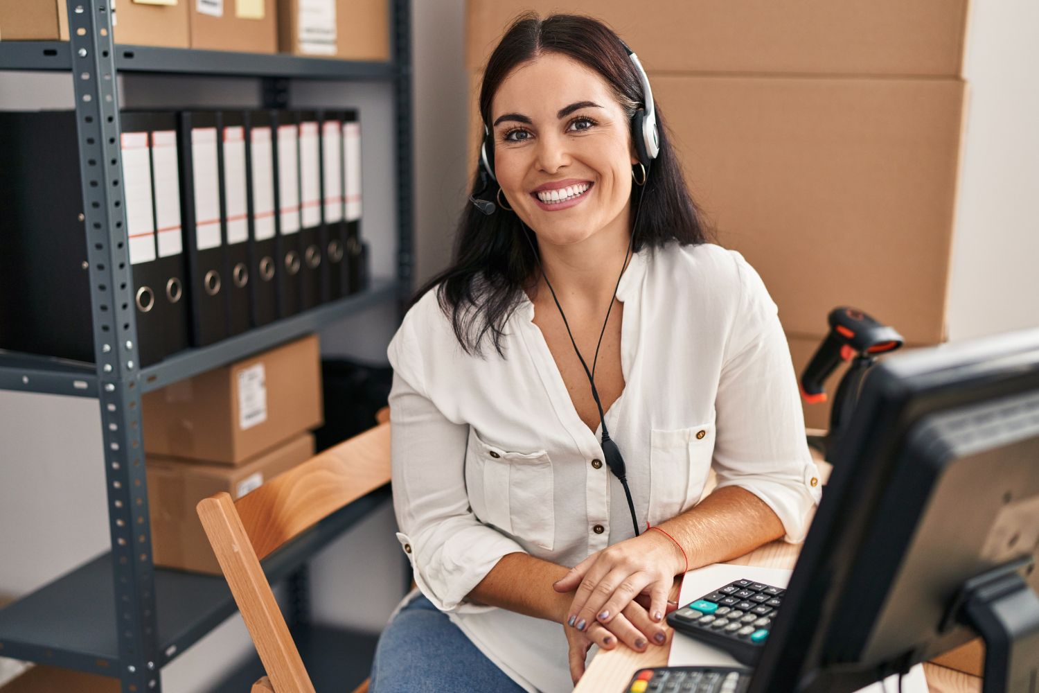  Image of an account representative smiling at the camera at her desk