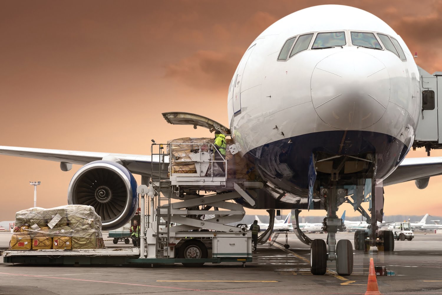 An image of airport staff loading a cargo airplane with commodities for shipment
