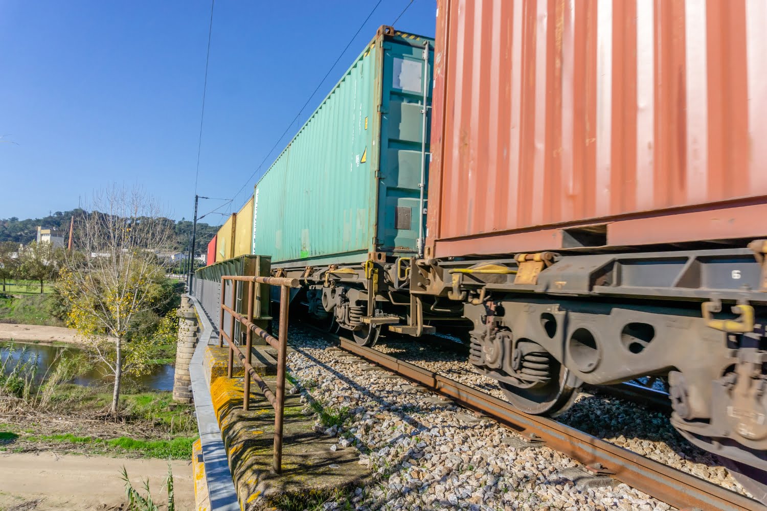 intermodal rail transportation train and box cars hauling goods