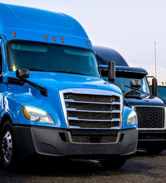 Image of blue and white semi trucks from a front-view