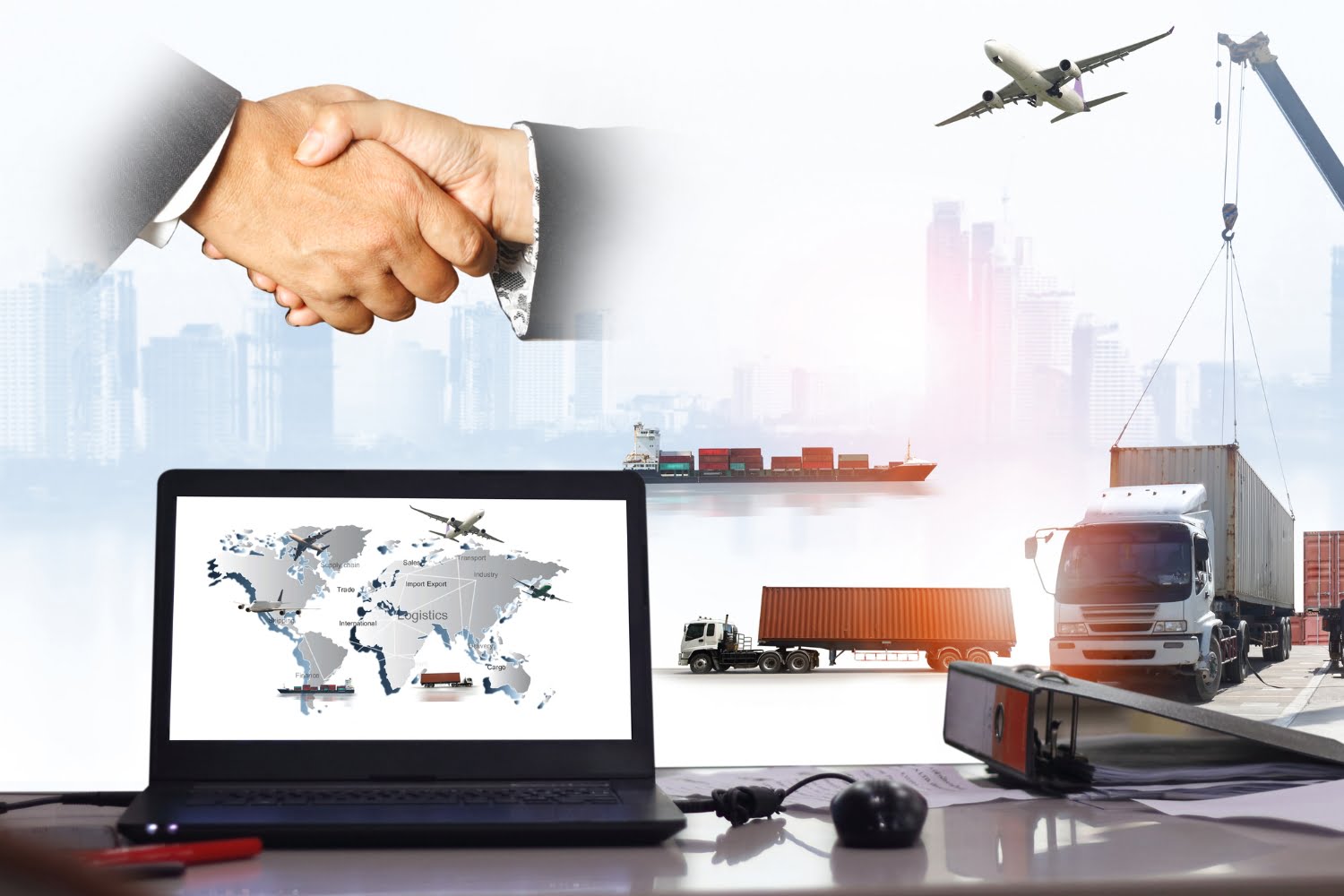 A supply chain network of an airplane, truck, and cargo ship with a city background next to a laptop and desk