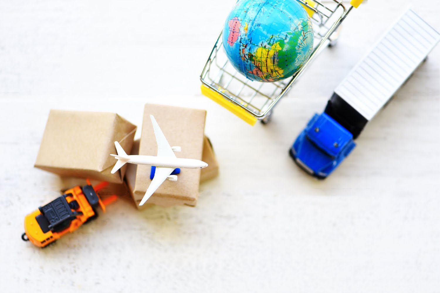 A supply chain network with a truck, airplane, globe, boxes, and shopping cart