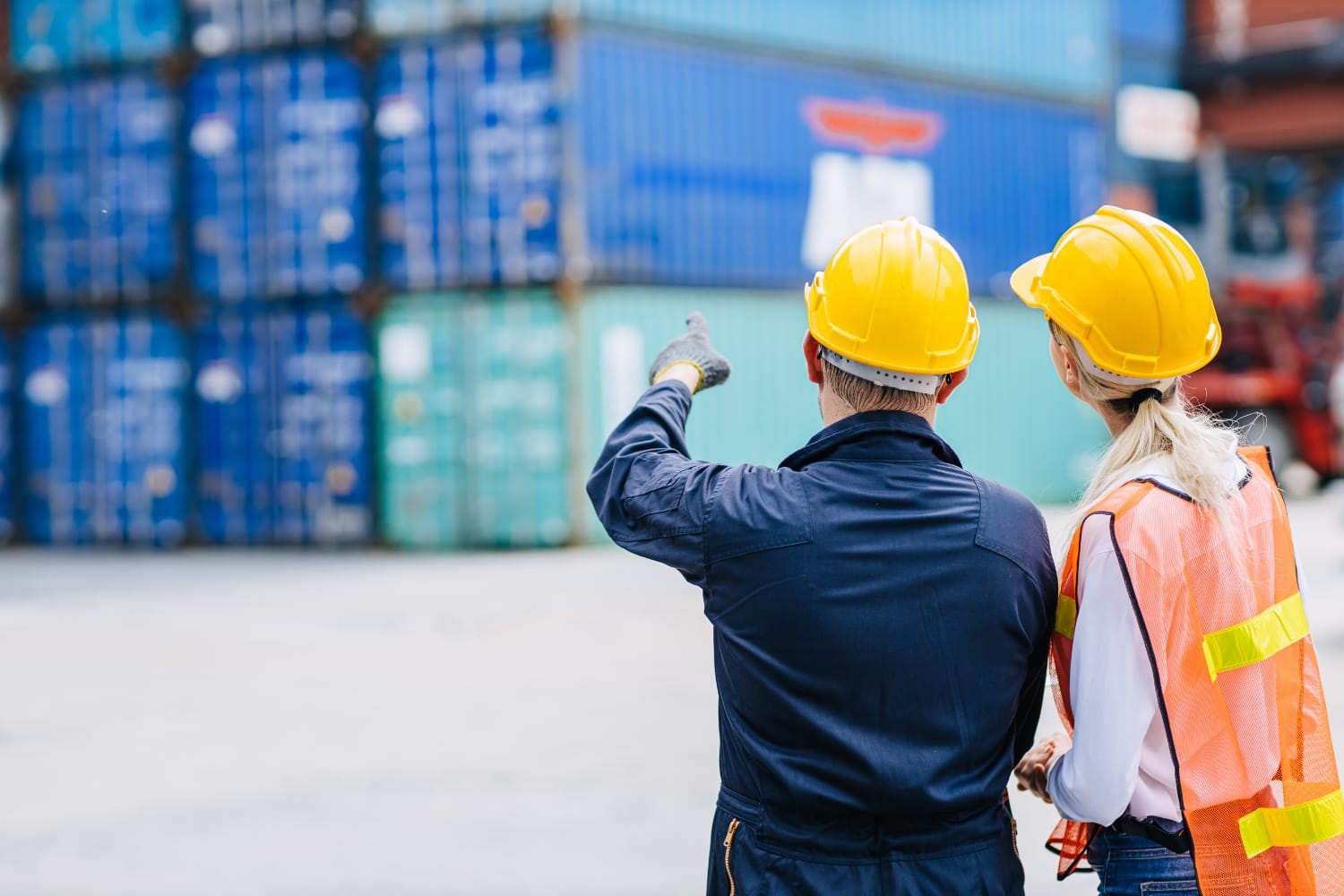 Image of two workers in discussion at a freight yard 