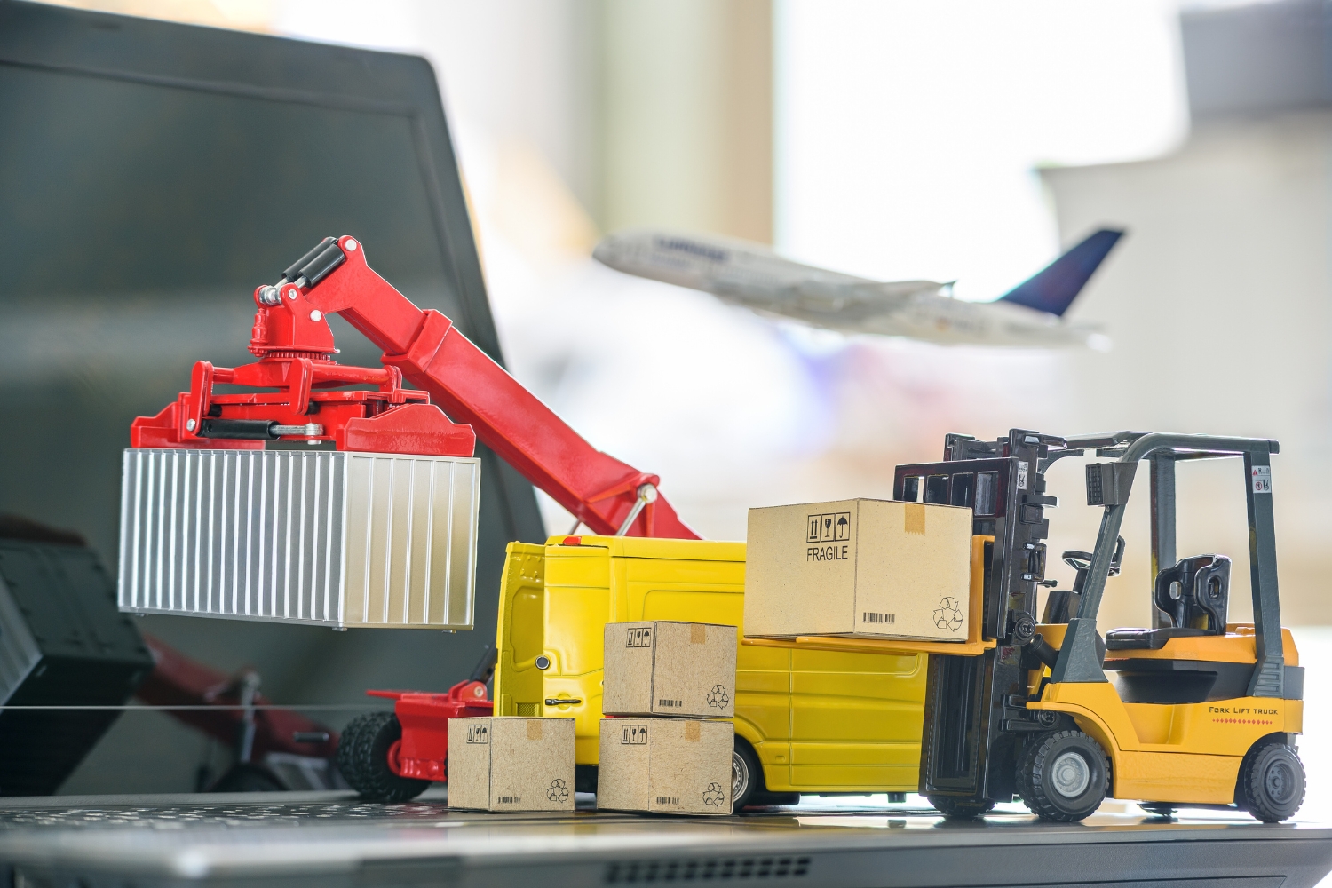 A graphic of different shipping modes and cardboard boxes on a laptop