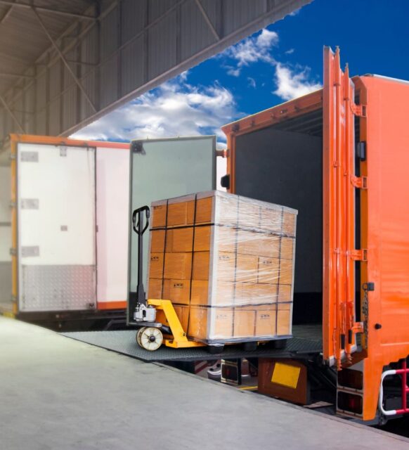Image of freight being loaded into the back of an open truck for shipping